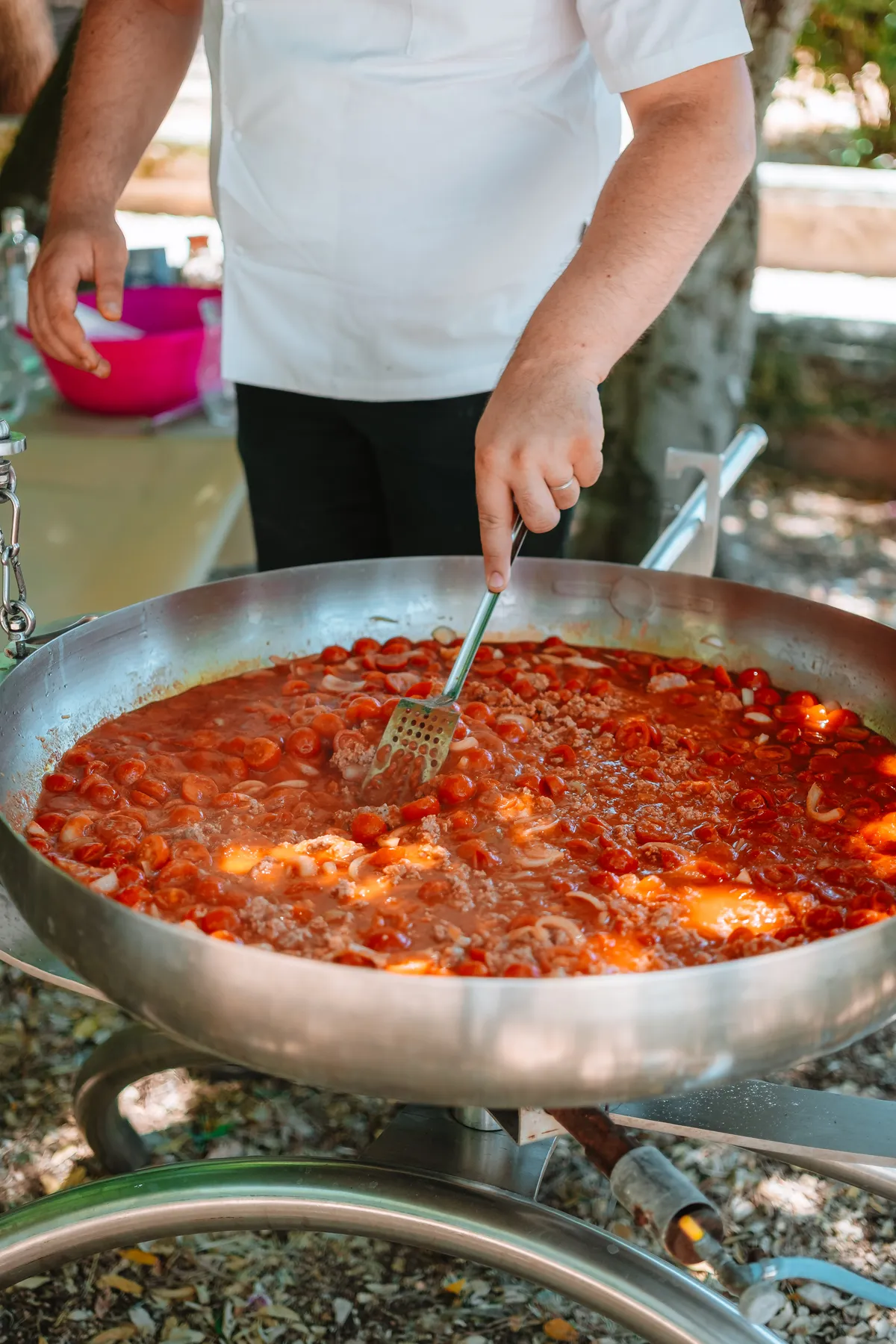 Sugo che cuoce in una grande padella all'aperto